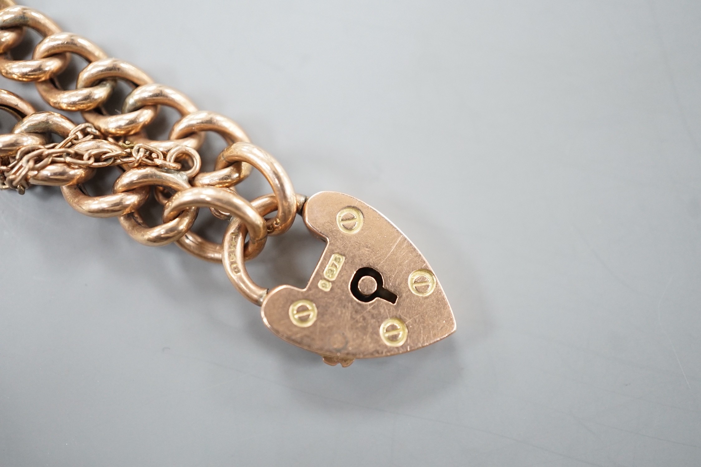 An Edwardian 9ct gold curblink bracelet, with heart shaped padlock clasp, 19cm, 11.3 grams.